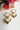 Gold heart-shaped earrings with gemstones